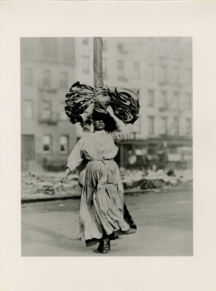 Lot #1051: LEWIS HINE - Italian Immigrant Woman Carrying Home Garments, Lower East Side, New York - Original photogravure