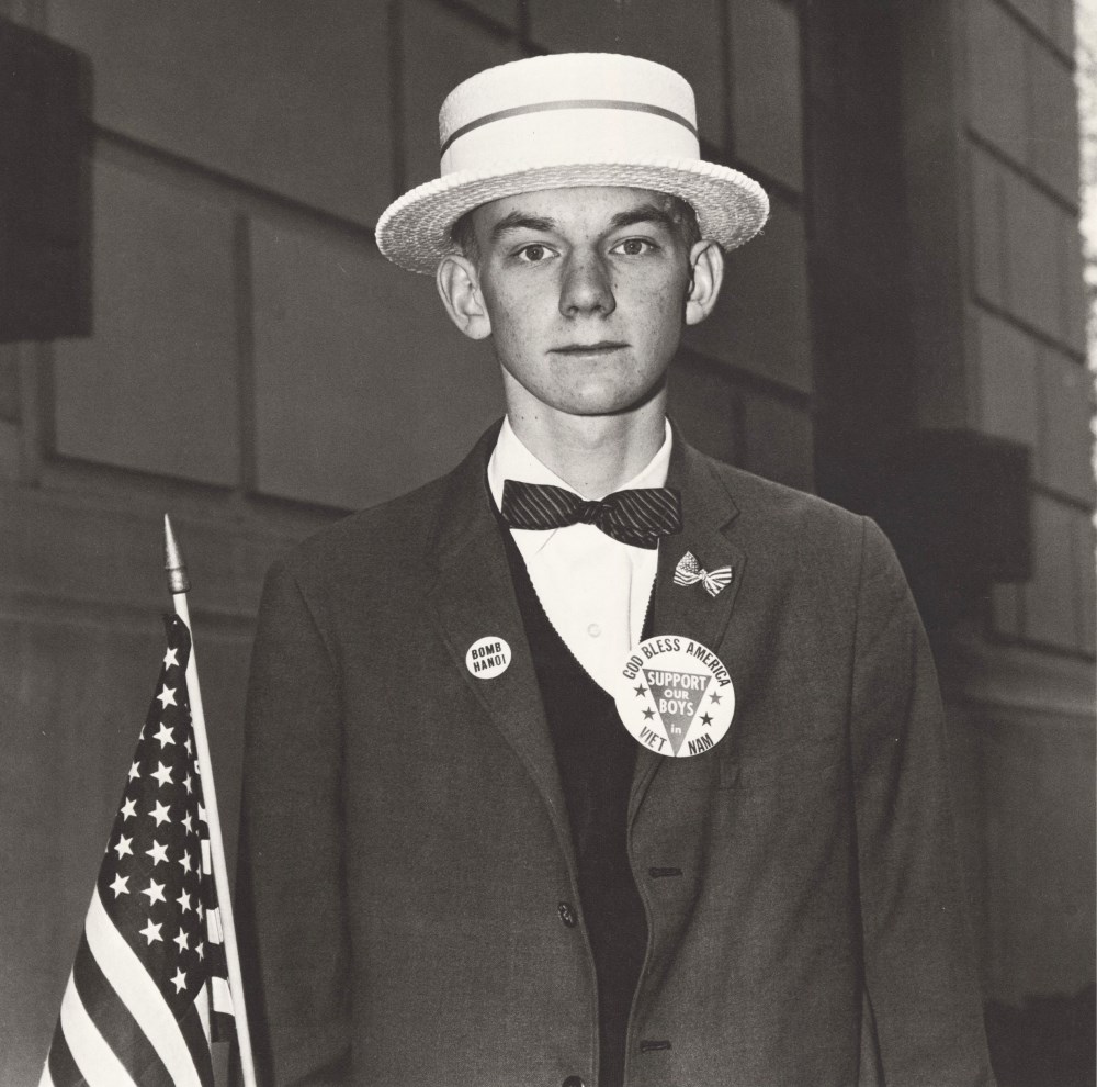Lot #839: DIANE ARBUS - Boy with a Straw Hat Waiting to March in a Pro-war Parade, N.Y.C - Original vintage photogravure