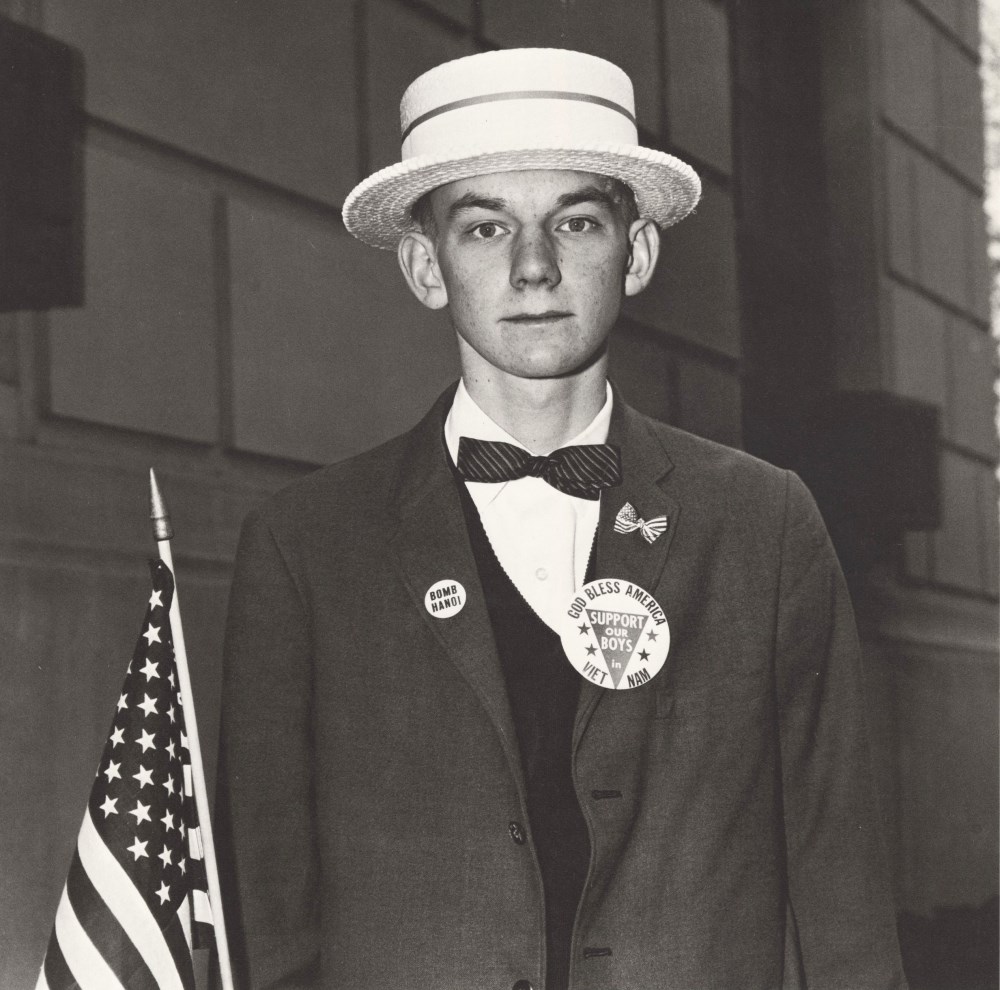 Lot #72: DIANE ARBUS - Boy with a Straw Hat Waiting to March in a Pro-war Parade, N.Y.C - Original vintage photogravure