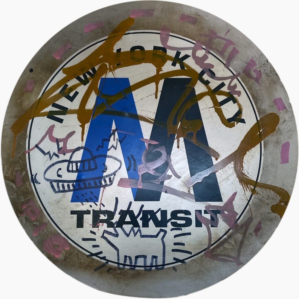 Lot #1375: KEITH HARING - Subway drawings: Barking Dog [and] Flying Saucer - Black marker drawings on vinyl decal on steel medallion